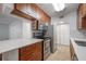Galley kitchen with stainless steel appliances, wood cabinets, and tiled backsplash at 3325 Bayshore Blvd # A17, Tampa, FL 33629