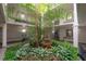 Interior lobby featuring a multi-story indoor garden, elevator access, and access to resident mailboxes at 3325 Bayshore Blvd # A17, Tampa, FL 33629