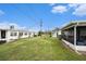 Spacious backyard view showcasing the screened porch and well-maintained lawn at 4325 93Rd N Ter, Pinellas Park, FL 33782