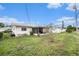 Charming backyard showcasing a screened porch and well-manicured landscaping at 4325 93Rd N Ter, Pinellas Park, FL 33782