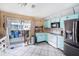 Bright eat-in kitchen featuring stainless appliances and sliding glass doors to screened lanai at 4325 93Rd N Ter, Pinellas Park, FL 33782