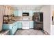Bright, functional kitchen featuring blue cabinets, modern appliances, and tiled floors for easy maintenance at 4325 93Rd N Ter, Pinellas Park, FL 33782