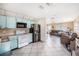Bright, open kitchen features blue cabinets, tiled floors, modern appliances, and an open layout for easy access at 4325 93Rd N Ter, Pinellas Park, FL 33782