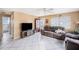 Spacious living room with neutral tones, tile flooring, cozy seating arrangements, and natural light from the windows at 4325 93Rd N Ter, Pinellas Park, FL 33782