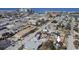 Aerial view of a coastal neighborhood with a home with a blue roof and palm trees in the front yard at 434 77Th Ave, St Pete Beach, FL 33706