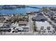 Aerial view showing a coastal community, water views, and commercial buildings in the foreground at 434 77Th Ave, St Pete Beach, FL 33706