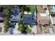 An aerial view shows the dark roof, green lawn, palm trees, and driveway of a home at 434 77Th Ave, St Pete Beach, FL 33706