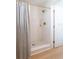 Bathroom featuring a tiled shower with glass door, gold hardware, and marble floor tiles at 434 77Th Ave, St Pete Beach, FL 33706