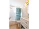 Updated bathroom features stylish vanity, gold fixtures, tiled walls, and a shower with a decorative curtain at 434 77Th Ave, St Pete Beach, FL 33706