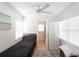 Cozy bedroom with ceiling fan, wood floors, and natural light from the large window and ample storage at 434 77Th Ave, St Pete Beach, FL 33706