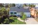 Charming single-Gathering home featuring a well-maintained lawn, a driveway, and small palm trees at 434 77Th Ave, St Pete Beach, FL 33706
