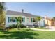 Charming single-story home with a well-manicured lawn, decorative shutters, and a cozy front porch at 434 77Th Ave, St Pete Beach, FL 33706