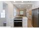 Open concept kitchen featuring a center island, modern appliances and a view of the dining room at 434 77Th Ave, St Pete Beach, FL 33706