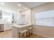 Bright, modern kitchen featuring white cabinetry, stainless steel appliances, and a breakfast bar at 434 77Th Ave, St Pete Beach, FL 33706