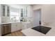 Well-lit kitchen with white cabinets, modern appliances, and a view of the adjacent space at 434 77Th Ave, St Pete Beach, FL 33706
