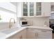 Bright kitchen with white cabinets, quartz countertops, and stainless steel appliances offering a modern aesthetic at 434 77Th Ave, St Pete Beach, FL 33706