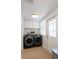 Well-lit laundry room with modern washer and dryer, white cabinets and an exterior door at 434 77Th Ave, St Pete Beach, FL 33706