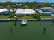 Aerial view of a waterfront home with a private dock, lush lawn, and water access at 4545 Clearwater Harbor N Dr, Largo, FL 33770