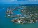 Picturesque aerial view of luxury waterfront homes with private docks nestled in a vibrant coastal community at 4545 Clearwater Harbor N Dr, Largo, FL 33770