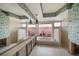 Bathroom with soaking tub, decorative wallpaper, and natural light ready for renovation at 4545 Clearwater Harbor N Dr, Largo, FL 33770