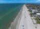 Beautiful aerial view of a sandy beach with people enjoying the sun and clear water at 4545 Clearwater Harbor N Dr, Largo, FL 33770