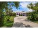 Charming home featuring a well-maintained lawn and circular driveway at 4545 Clearwater Harbor N Dr, Largo, FL 33770