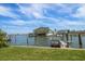 Beautiful waterfront property featuring a lush lawn and a private dock at 4545 Clearwater Harbor N Dr, Largo, FL 33770