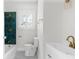 Beautifully renovated bathroom features a glass tile accent wall and decorative glass shower at 459 Bell Ave, Brooksville, FL 34601