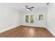 Minimalist bedroom featuring a ceiling fan, wood-look floors, and plenty of natural light at 459 Bell Ave, Brooksville, FL 34601