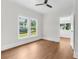 Bright bedroom featuring hardwood floors, neutral paint, and large windows offering ample natural light at 459 Bell Ave, Brooksville, FL 34601