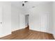 A cozy bedroom features a pair of white doors, wood-look flooring and neutral paint at 459 Bell Ave, Brooksville, FL 34601
