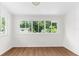 Sun-drenched room features hardwood floors and a large window with backyard views at 459 Bell Ave, Brooksville, FL 34601