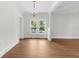 Dining room with a chandelier, wood flooring, and large windows overlooking the outdoors at 459 Bell Ave, Brooksville, FL 34601
