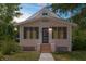 Charming single Gathering home with a front entrance and a concrete walkway, under a partly cloudy sky at 459 Bell Ave, Brooksville, FL 34601