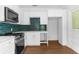 Kitchen featuring stainless steel appliances, including a range, microwave, and a sink with gold fixtures at 459 Bell Ave, Brooksville, FL 34601