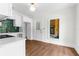 Bright kitchen with white cabinets, modern appliances, and a stylish green tile backsplash at 459 Bell Ave, Brooksville, FL 34601