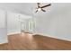 Bright, open-concept living room with white walls, wood floors, and ample natural light at 459 Bell Ave, Brooksville, FL 34601