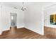 Cozy, brightly lit room showcasing beautiful flooring and a glimpse into an adjoining bathroom at 459 Bell Ave, Brooksville, FL 34601