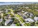 Aerial view of home showcasing proximity to lush green surroundings and waterfront at 460 Althea Rd, Belleair, FL 33756