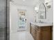 Bright bathroom featuring a vanity, hardwood floors, and access to the pool area at 460 Althea Rd, Belleair, FL 33756