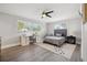 Bright bedroom featuring a fan, hardwood floors, and a desk area at 460 Althea Rd, Belleair, FL 33756