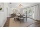 Bright dining area features modern furniture, drapery, and updated lighting fixtures at 460 Althea Rd, Belleair, FL 33756