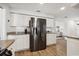 Updated kitchen featuring stainless steel appliances, granite counters, and white cabinets at 460 Althea Rd, Belleair, FL 33756