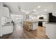 Open kitchen featuring an island, modern appliances, granite counters, and a dining area in view at 460 Althea Rd, Belleair, FL 33756