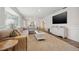 Large living room showcasing an oversized sectional, modern furniture, and plenty of natural light at 460 Althea Rd, Belleair, FL 33756