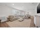 Bright living room features a large, comfortable sectional and updated fixtures and finishes at 460 Althea Rd, Belleair, FL 33756