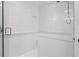 Bright all-white shower features tile accents, a glass door, and modern fixtures at 460 Althea Rd, Belleair, FL 33756