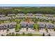 Aerial view of the townhome with nearby homes and trees at 4653 Ancona Way, Wesley Chapel, FL 33543