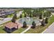 Aerial view showcasing the community's fountain, landscaping, clubhouse, and surrounding residential area at 4653 Ancona Way, Wesley Chapel, FL 33543