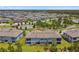 Aerial view of the townhome with a view of the pond and landscaping at 4653 Ancona Way, Wesley Chapel, FL 33543